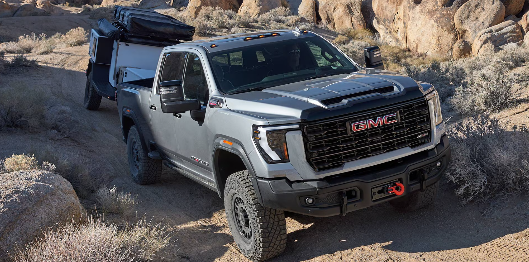 2026-GMC-Sierra-2500-hauling-equipment-in-rugged-terrain
