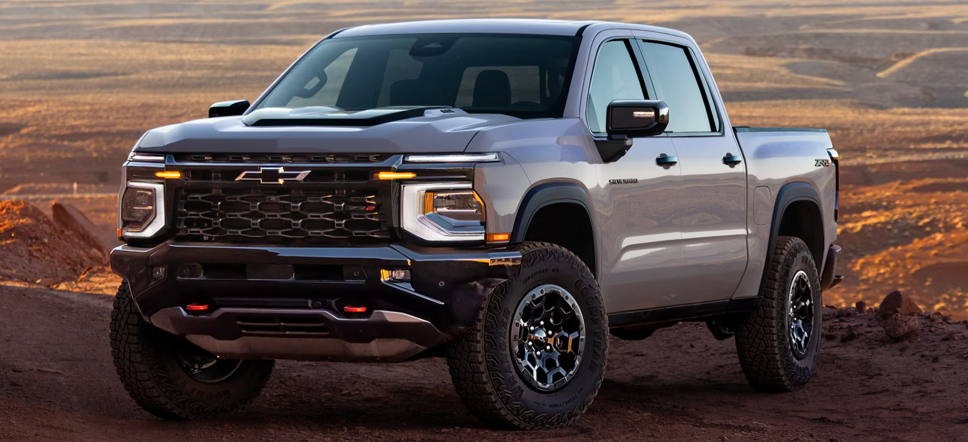 Gray 2027 Chevrolet Silverado 1500 parked on desert mountaintop